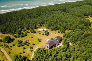 an aerial view of a house on a hill next to the ocean at Guest House "Stellas" in Ziemupe