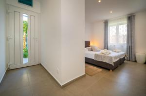 a bedroom with a bed and a window at Apartment Juranić II with pool in Baška +12 photos