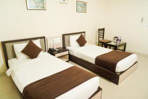 Cama o camas de una habitación en Hotel Yash Regency