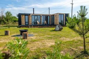 a tiny house in the middle of a yard at VyriY House 