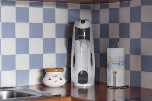 a coffee maker sitting on a counter in a kitchen at la petit maisonette de manu in Cannes