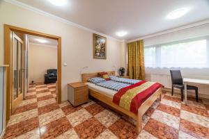 a bedroom with a bed and a desk and a window at Apartmán blizko centra Prahy in Prague