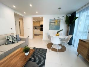 a living room with a couch and a table at VILLA ONEUM - Apartment MARE with privat JACUZZI in Omiš +13 photos