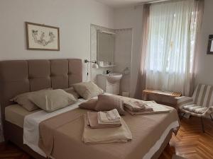 a bedroom with a large bed with towels on it at Apartments Lorenandreja in Rab +41 photos