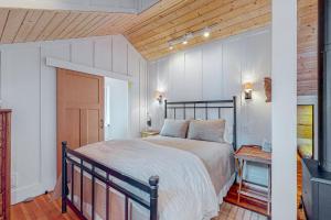 een slaapkamer met een groot bed en een houten plafond bij Boat House in Shelter Cove