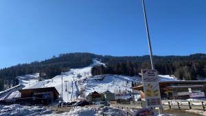 a ski resort with a ski lift in the snow at Kreischberg Chalet Ferienpark 3 in Sankt Lorenzen ob Murau