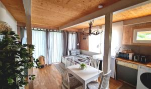 a kitchen with a table and a white table and chairs at Kreischberg Chalet Ferienpark 3 in Sankt Lorenzen ob Murau