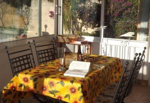 a table with a laptop sitting on top of it at Casa Solemar in Imperia