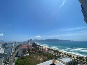 a view of the beach and ocean from a building at Muong Thanh Luxury Apartment Seaview in Danang