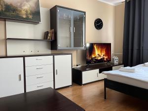 a bedroom with a bed and a fireplace at Elegant Escape apartment - free parking, easy access to City Centre in Bratislava