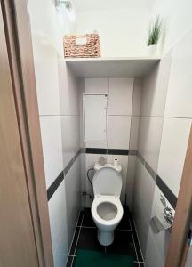 a bathroom with a toilet in a small room at Elegant Escape apartment - free parking, easy access to City Centre in Bratislava