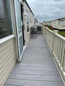 a deck with a view of a house at Konies Place Golden Anchor Free WiFi Bedding Included in Chapel Saint Leonards