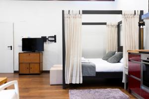 a bedroom with a bunk bed and a television at Loft by Basquelidays in Hondarribia