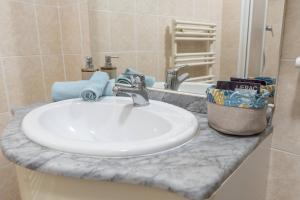 a bathroom counter with a white sink and a mirror at la petit maisonette de manu in Cannes +29 photos