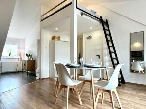 a dining room with a table and chairs and a ladder at MyStay: *Travel & Business* in Nußloch