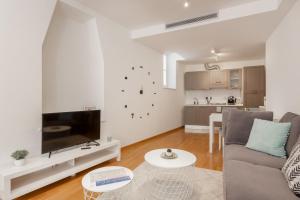 a living room with a couch and a table at Suite Saba, stile e parcheggio in centro a Trieste in Trieste