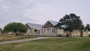 a house with a fence in front of it at Canterburg Stables in George