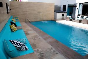 a pool in a house with a blue swimming pool at REF House Barra Da Tijuca in Rio de Janeiro