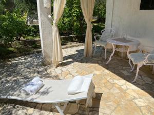 a patio with a table and chairs and a table and chairs at Apartments Lorenandreja in Rab