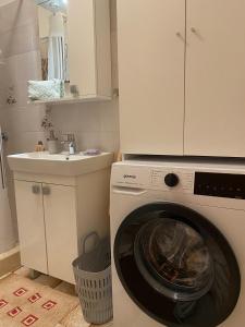 a washing machine in a kitchen with a sink at Holiday home Mandi in Vrbanj