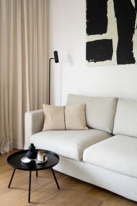 a living room with a white couch and a table at Unique & Modern Apartment Zabłocie in Krakow