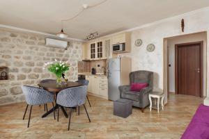 een keuken en eetkamer met een tafel en stoelen bij Apartments Konoba 224 in Kotor