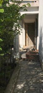 an entrance to a building with a bench in a courtyard at Apartments Lorenandreja in Rab