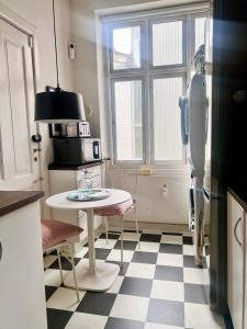 Ultimate Luxury in Kgs. Nytorv في كوبنهاغن: مطبخ صغير مع طاولة وثلاجة