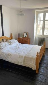 a bedroom with a bed and a dresser and a window at Lovely French Farmhouse with Private Swimming Pool in Bourganeuf