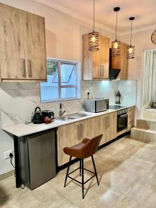 a kitchen with wooden cabinets and a chair in it at 435 on vale boutique aparthotel in Johannesburg