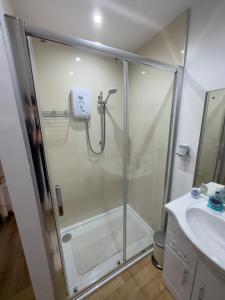 a bathroom with a shower and a sink at Clare Forest Apartment in Ballycastle