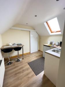 a kitchen with a table and two stools in a room at Clare Forest Apartment in Ballycastle