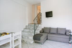 a living room with a couch and a tv at Villa Marina in Perdika