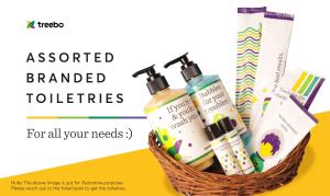 a basket ofented branded toothbrushes and cosmetics at Treebo Trend Excellent Home in Pune
