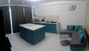 a kitchen and living room with a couch and a table at Iris Apartament Eforie Nord in Eforie Nord