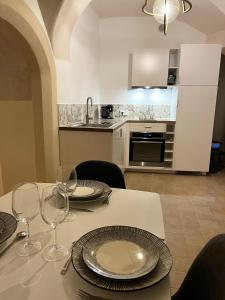 a kitchen with a table with plates and wine glasses at La Source in Saint-Saturnin-de-Lucian +16 photos