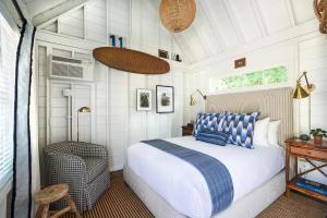 a bedroom with a bed and a desk and a window at Wanderer Cottages in Kennebunk