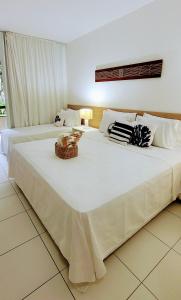 Ένα ή περισσότερα κρεβάτια σε δωμάτιο στο ILOA Residence Flat Alagoas
