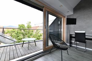 Habitación con balcón con mesa y sillas. en Gîte Contemporain L'hirondelle, en Guémar