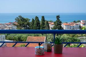 a table on a balcony with a view of a city at Nota's Home in Flogita