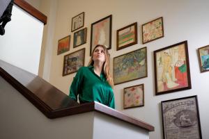 a woman standing in front of a wall of art at Morton Hotel in London