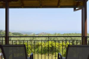 a view from the balcony of a house with chairs at View of the Castle and the Sea 1 in Platamonas