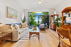 a living room with a couch and a table at Hale Mahina A103 in Kahana