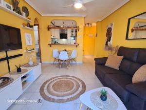 a living room with a couch and a table at Apartamento Parquemar in La Mata