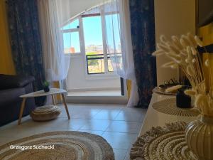 a living room with a couch and a window at Apartamento Parquemar in La Mata