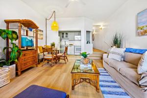 a living room with a couch and a table at Hale Mahina A103 in Kahana