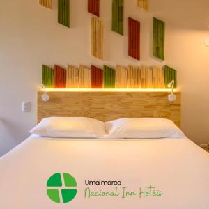 Postel nebo postele na pokoji v ubytování Hotel Nacional Inn Curitiba Santa Felicidade