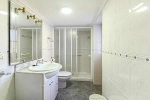 a bathroom with a sink and a toilet and a shower at Casa Vacacional Paula in Llanes +21 photos