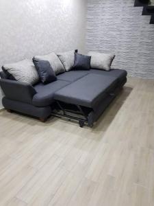 a black couch sitting in a living room at My House in Borjomi