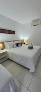 Posteľ alebo postele v izbe v ubytovaní ILOA Residence Flat Alagoas